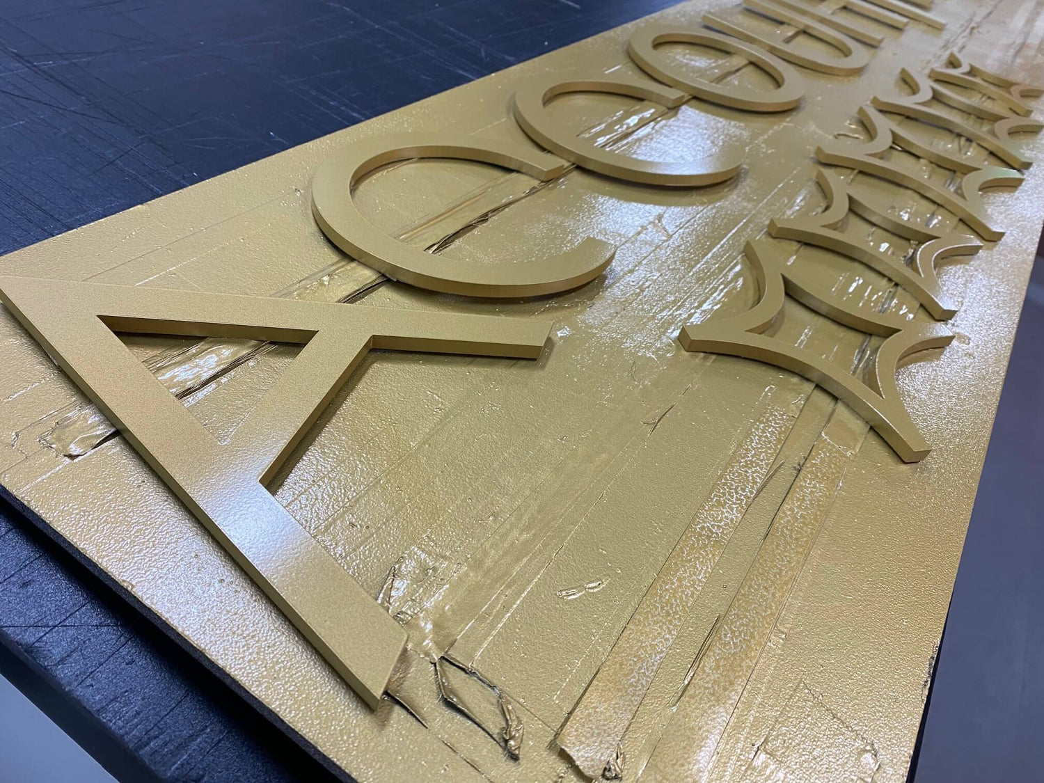 pantone gold spray painted sign